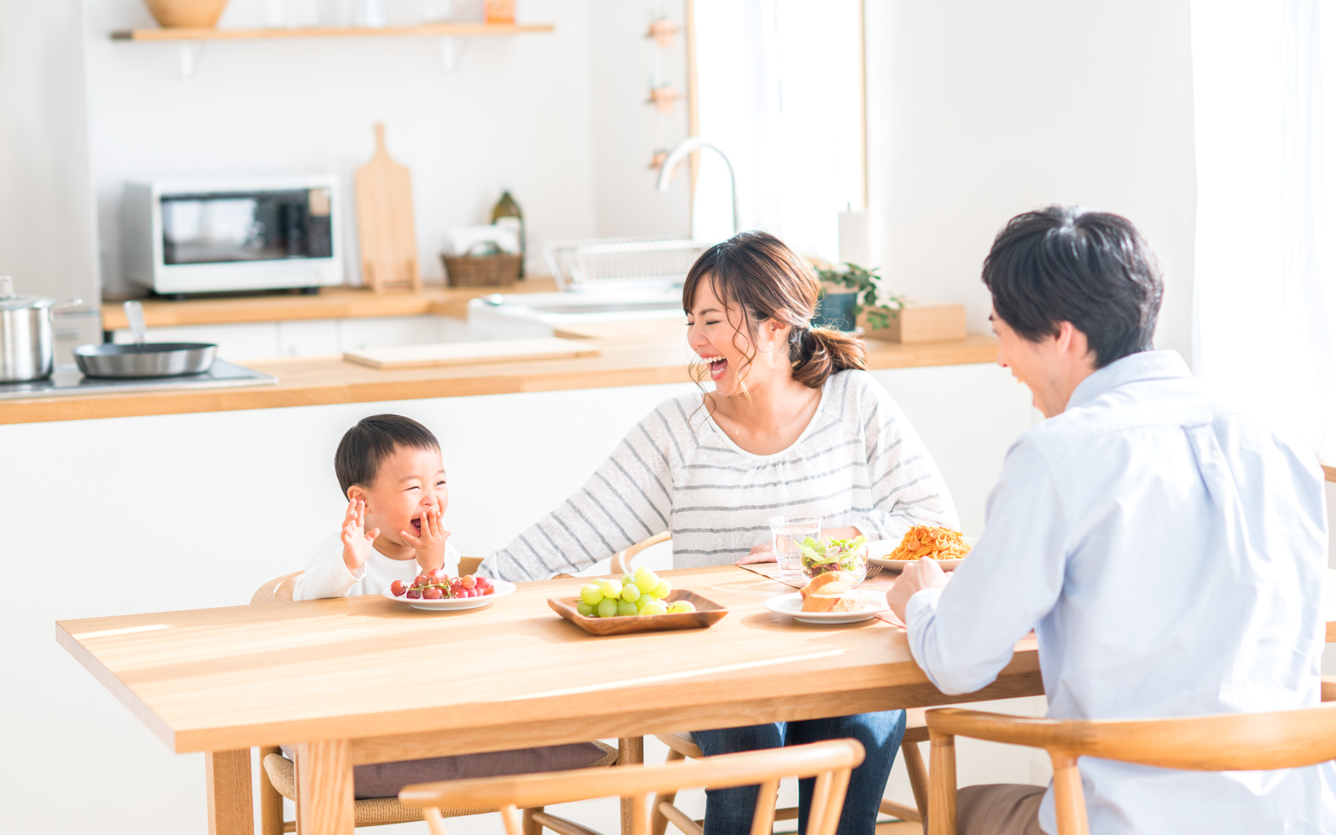 家族が果物を食べて晴ればれ笑顔が溢れる写真